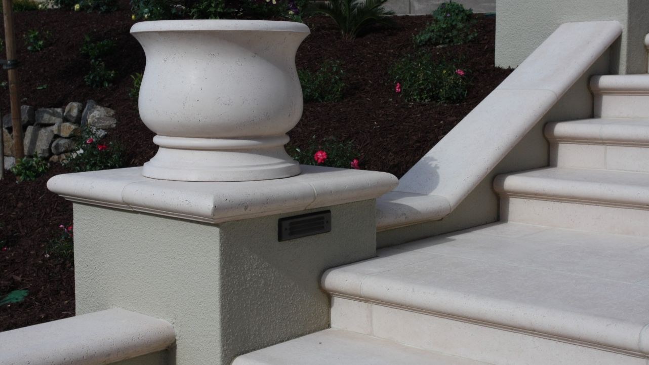 stone wall caps and precast planters backyard design