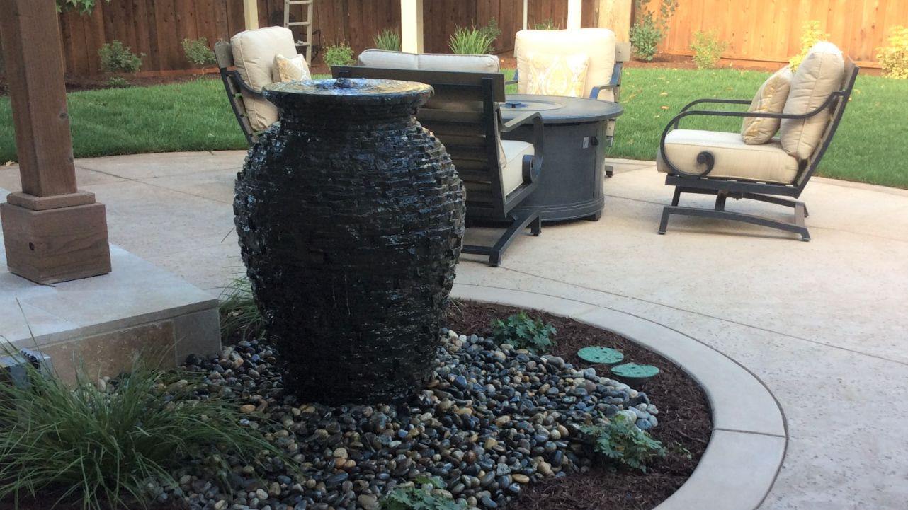 backyard water feature urn on a new patio