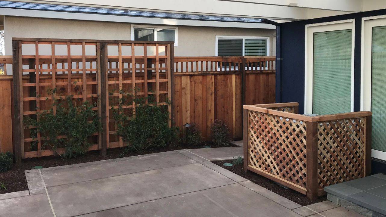 wood trellis ac screen in small backyard renovation
